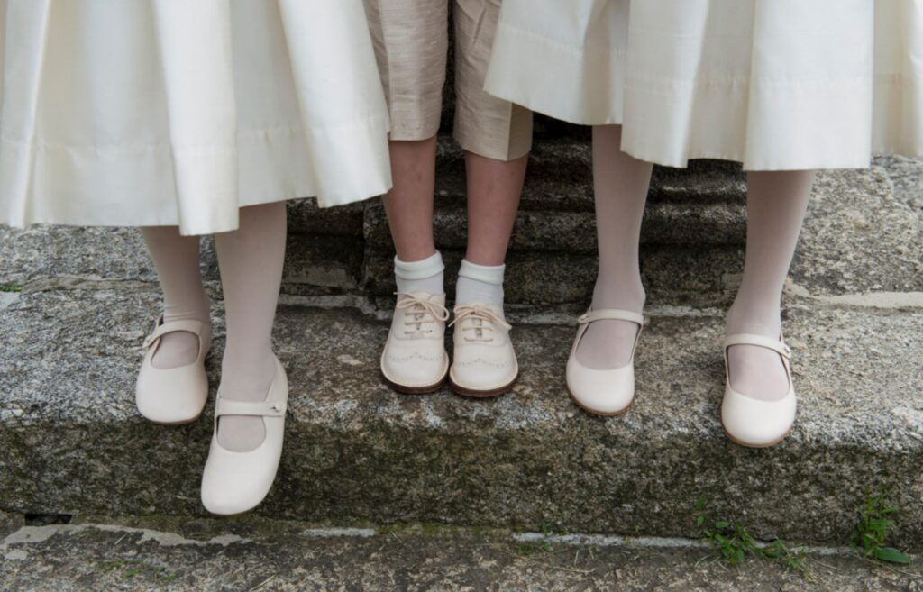 children feet with white socks and shoes