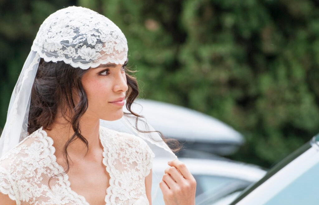 retro vintage bride wearing a lace hat by atelier crespi wedding dresses in itay