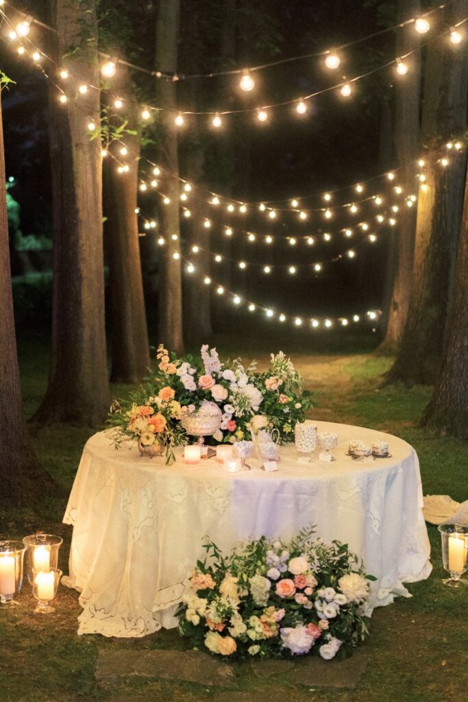outdoor wedding setting in the forest with fairylights planned by destination wedding planner in italy atelier crespi