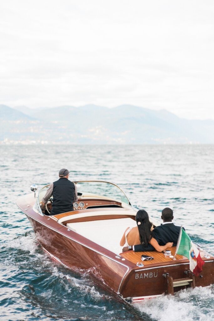boat carrying the bride and groom taking them to their wedding venue in lake como for a destination wedding in Italy planned by atelier crespi wedding planner