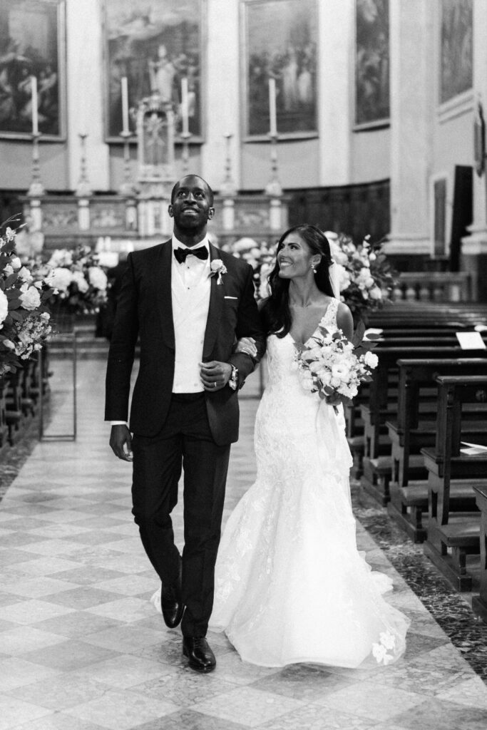 bride and groom exiting the church where they got married in lake como