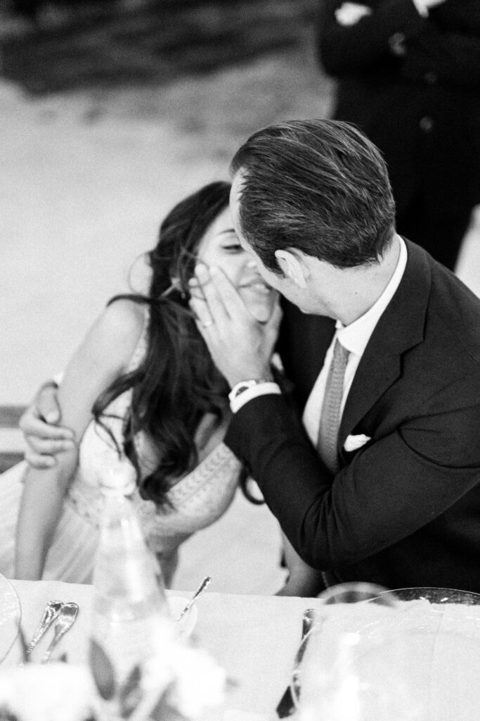 destination wedding in italy - bride and groom kissing in their wedding celebration in tuscany by atelier crespi wedding planner