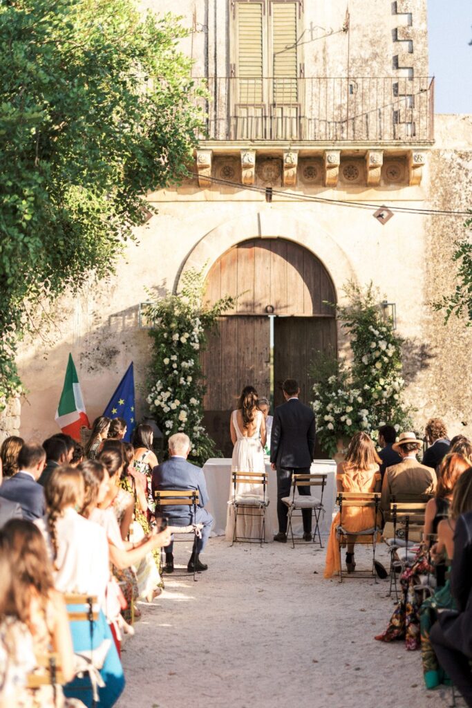 wedding ceremony in italy while guests overlook the bride and groom