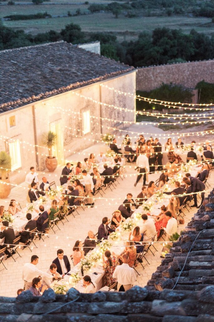dreamy destination wedding in italy dinner in a vineyard with fairylights in the blue hour