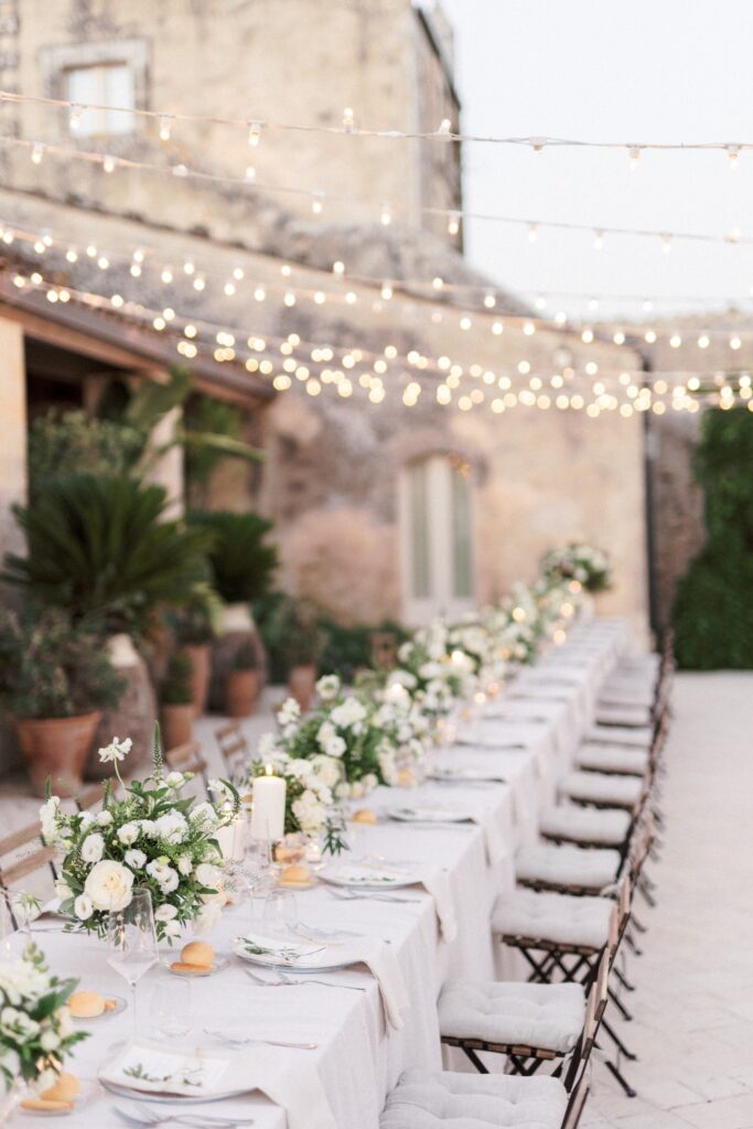 fairy lights and floral arrangements for a destination wedding in tuscany designed by atelier crespi italy wedding planner